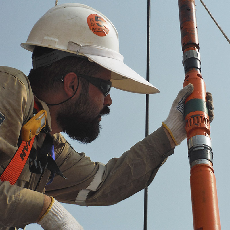 Field Engineer inspecting Slim Line ESP on wellsite